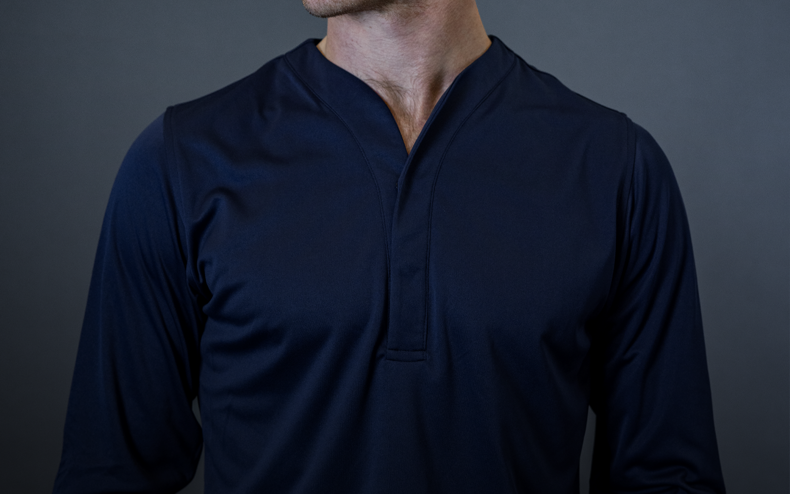man wearing cheegs collarless dress shirt in dark blue.