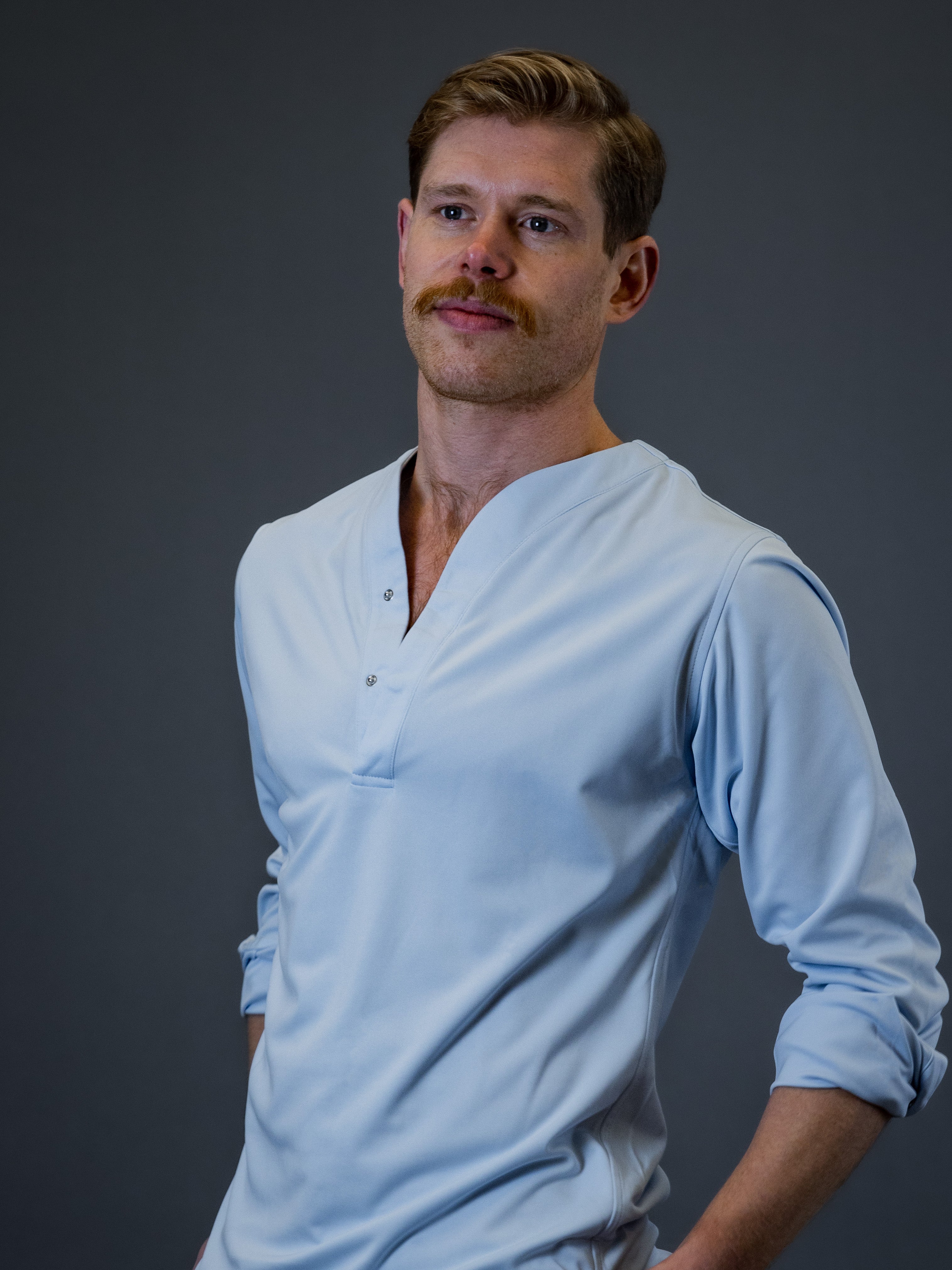 Young model wearing a cheegs luxury collarless dress shirt in light blue