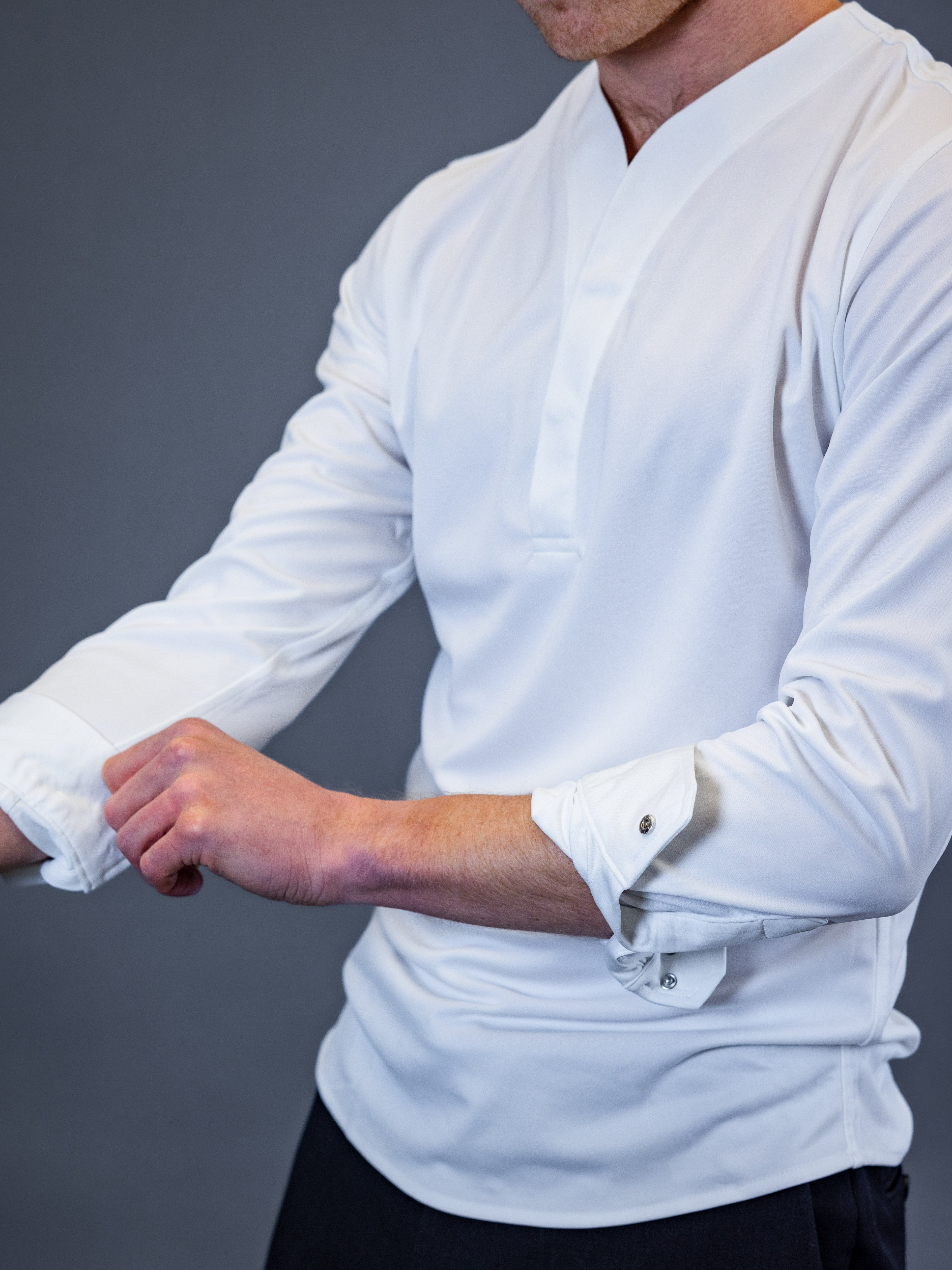 slim model showing the metallic buttons on a cheegs dress shirt