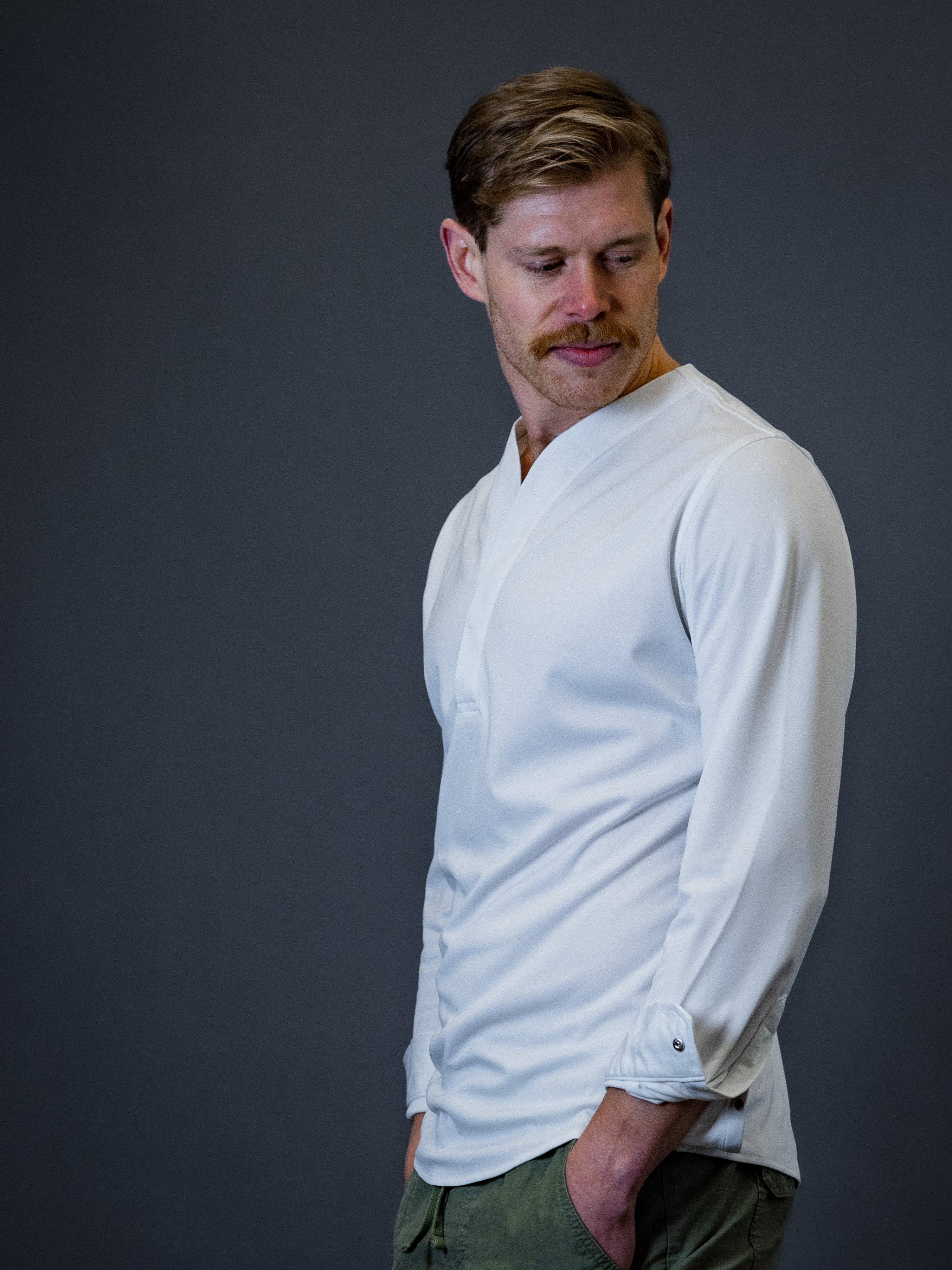 young model wearing modern collarless shirt made by Cheegs Apparel
