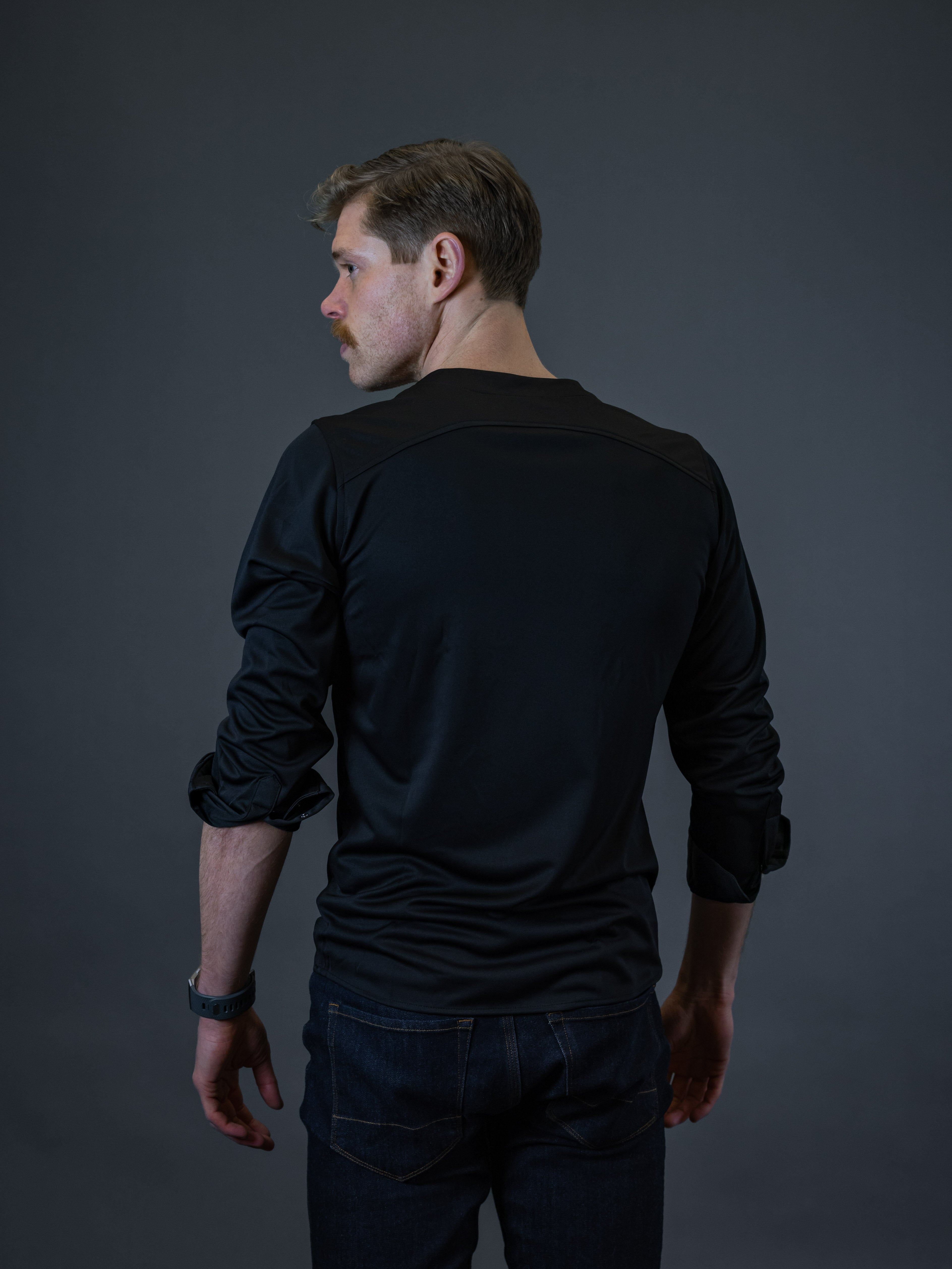 man wearing a mens collarless shirt with casual pants