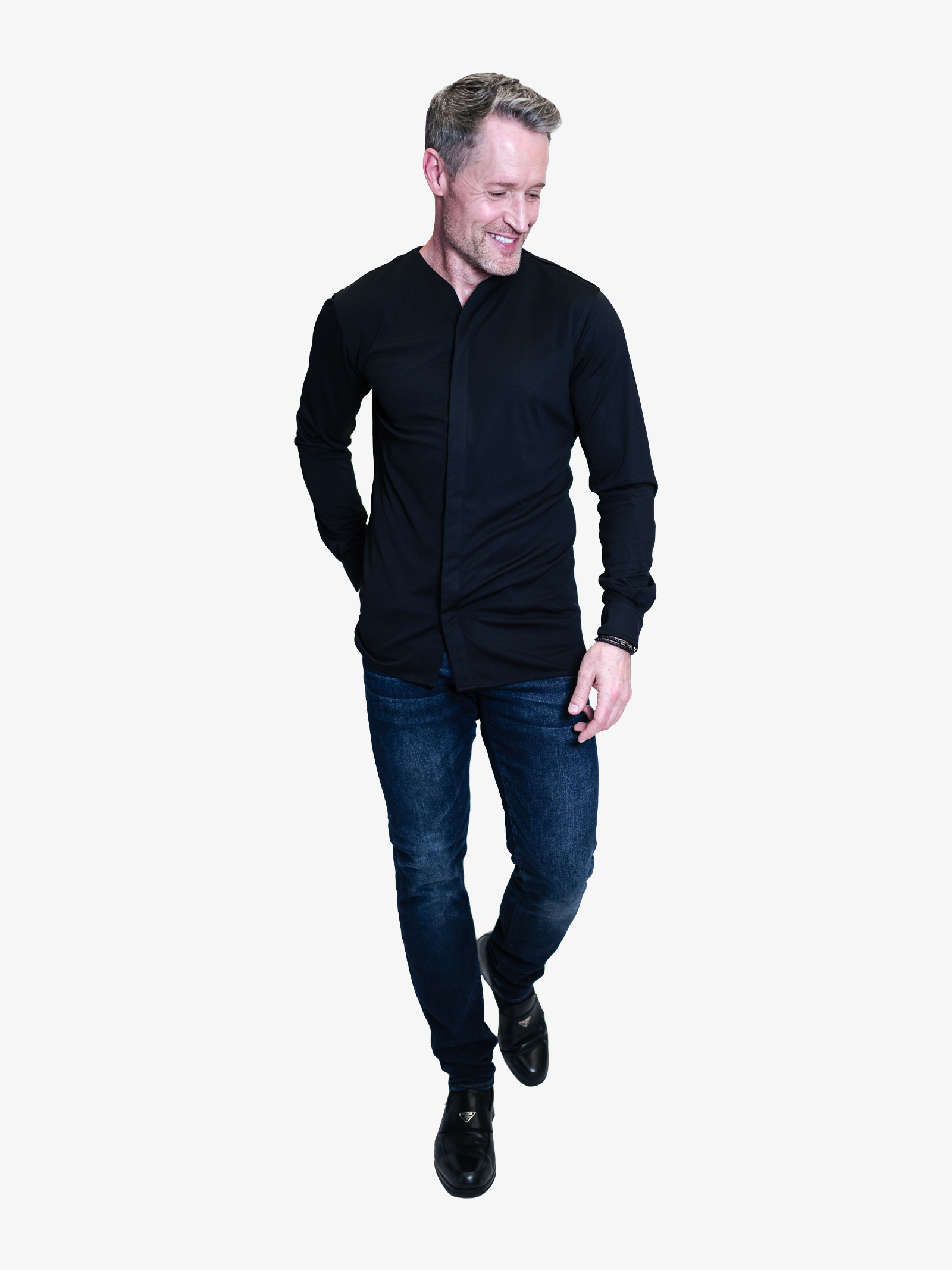 Man wearing a black dress shirt that is collarless with a nice pair of blue jeans. Worn untucked with black dress shoes