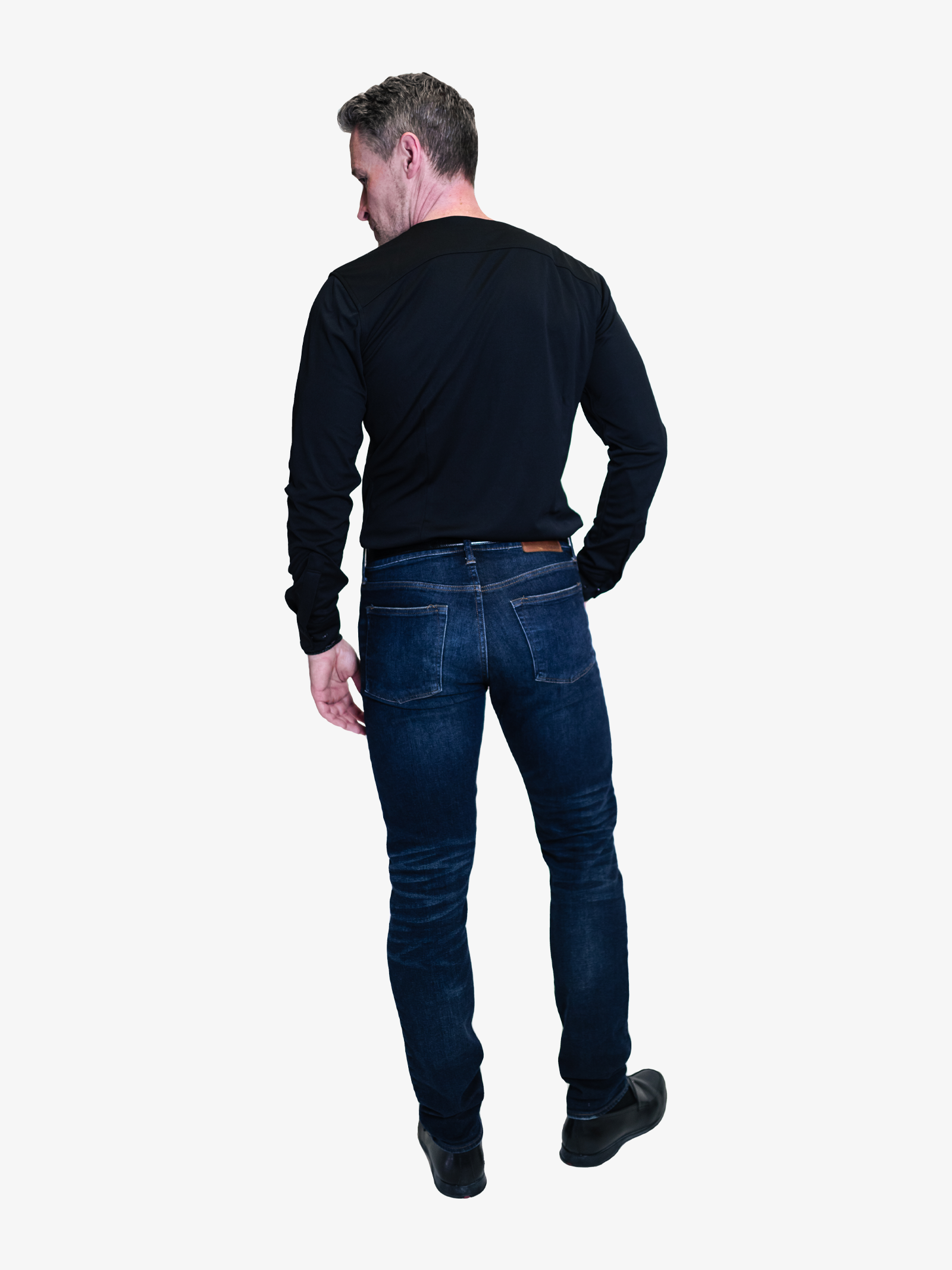man turned with his back facing the camera wearing a black collarless dress shirt