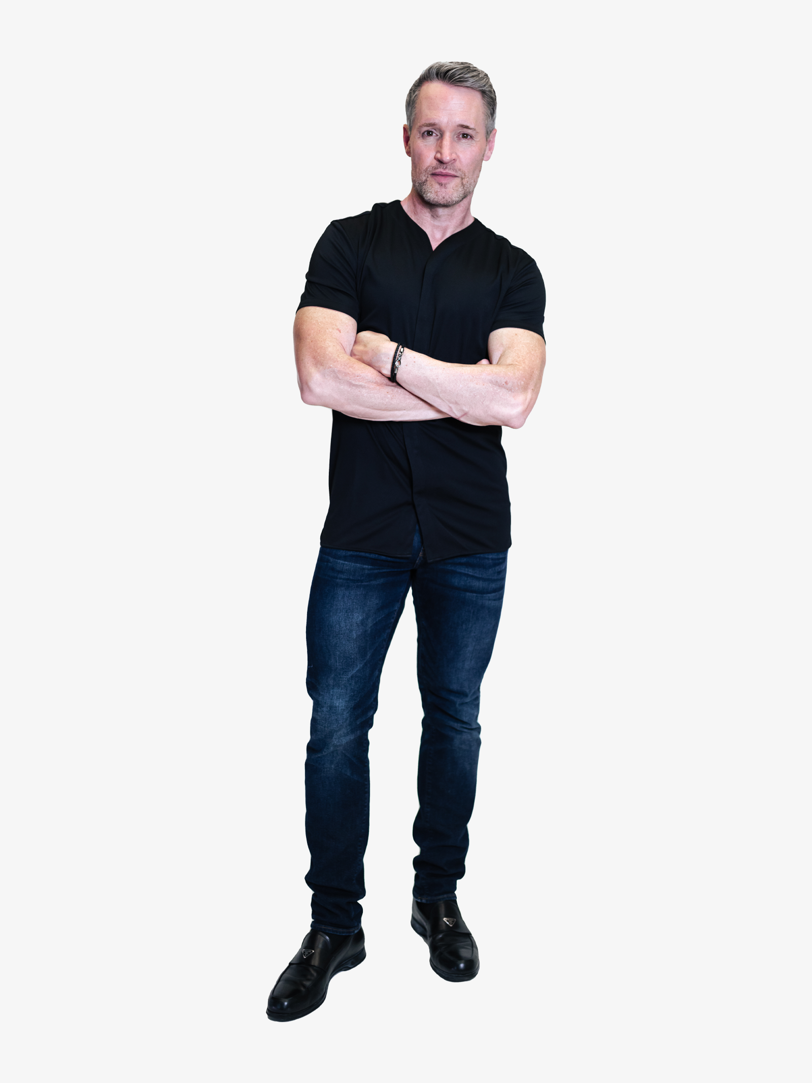 model wearing black dress shirt untucked with formal dark jeans
