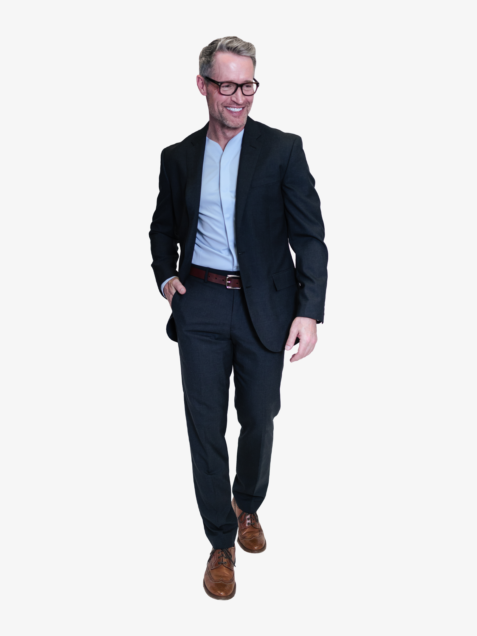 man smiling in his light blue collarless long sleeve worn with a dark blue suit.