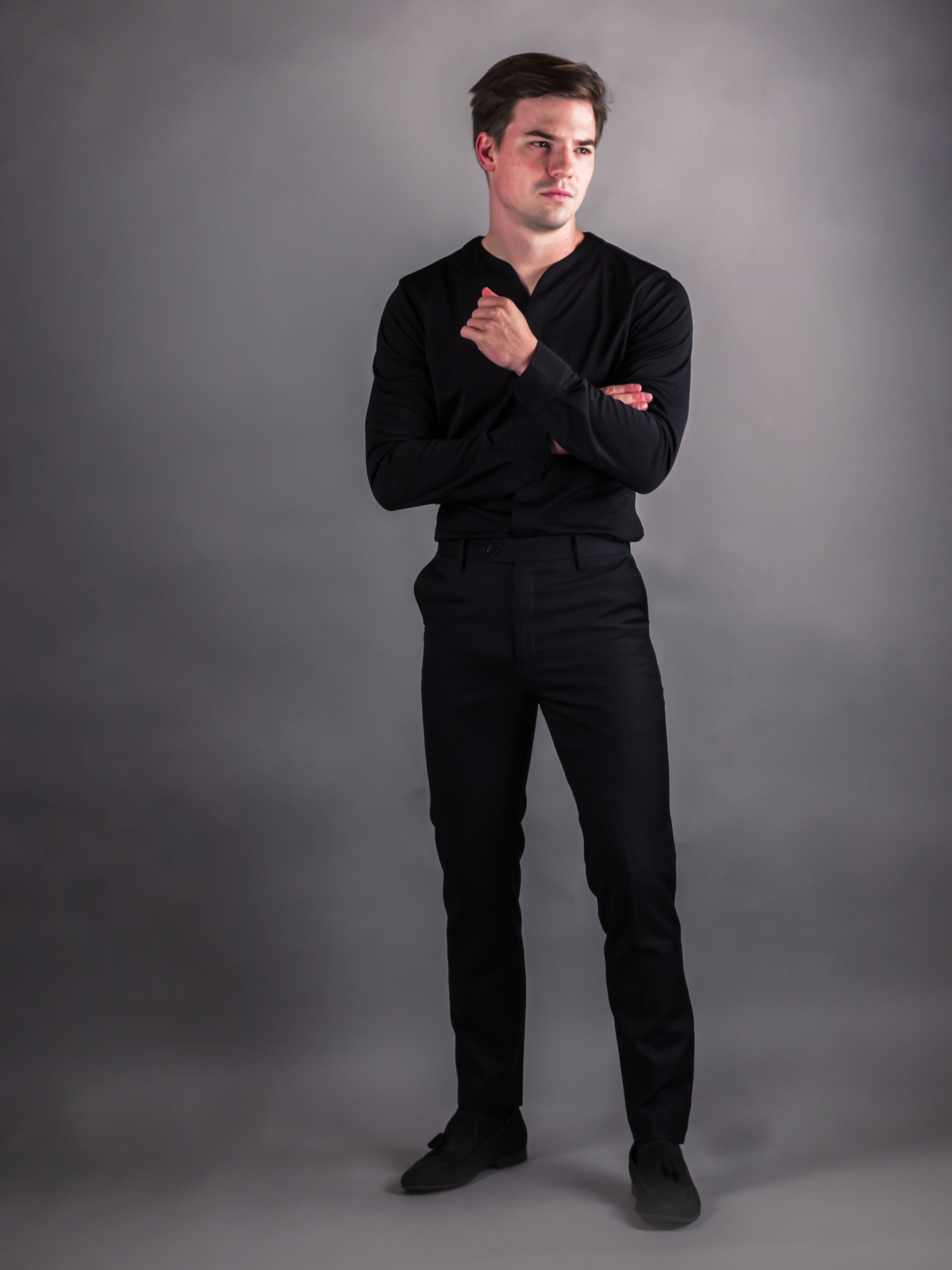 Man wearing Long sleeve black cheegs shirt with dark pants for a modern style