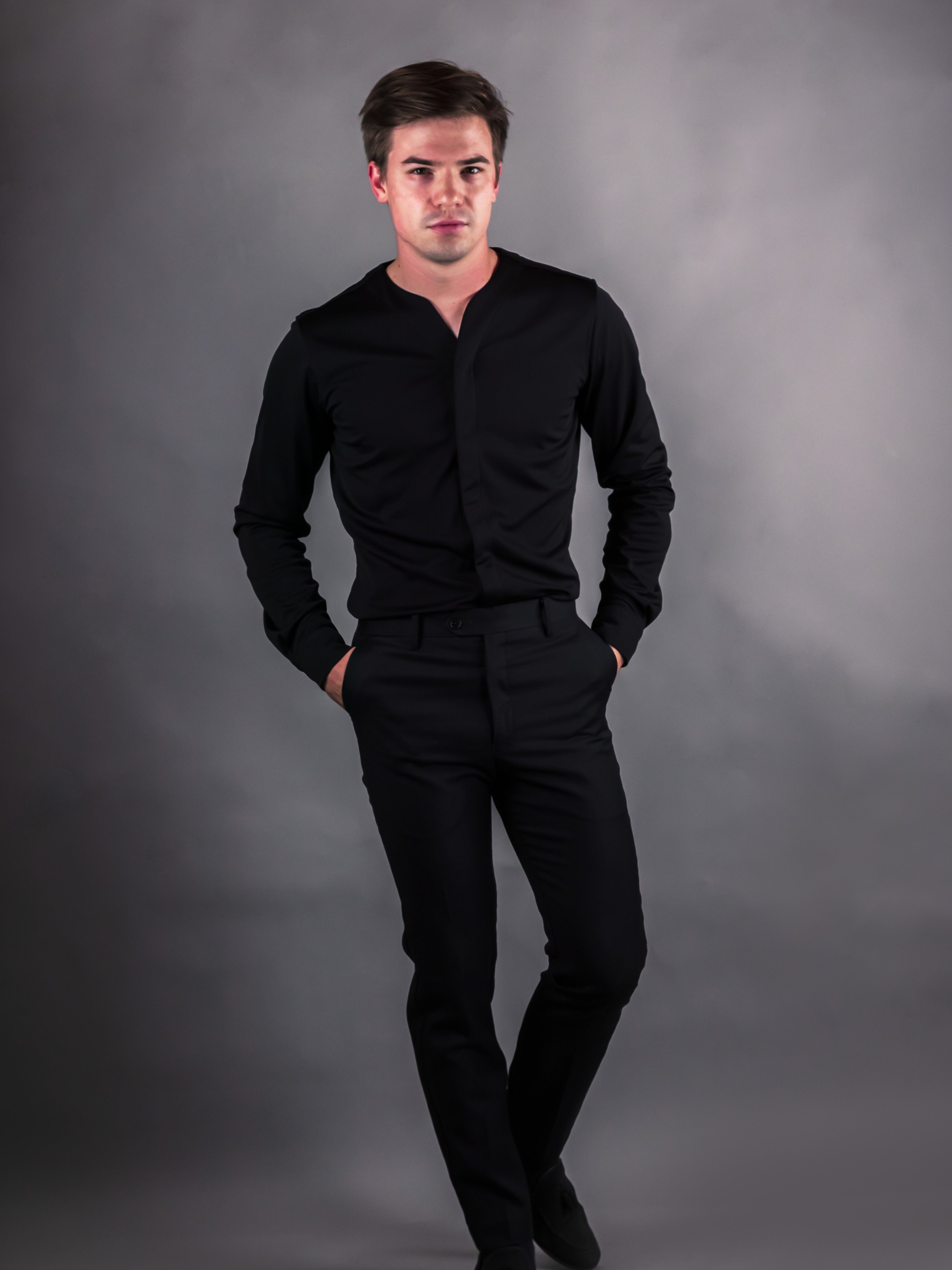 man wearing all black with a modern dress shirt styled by Cheegs