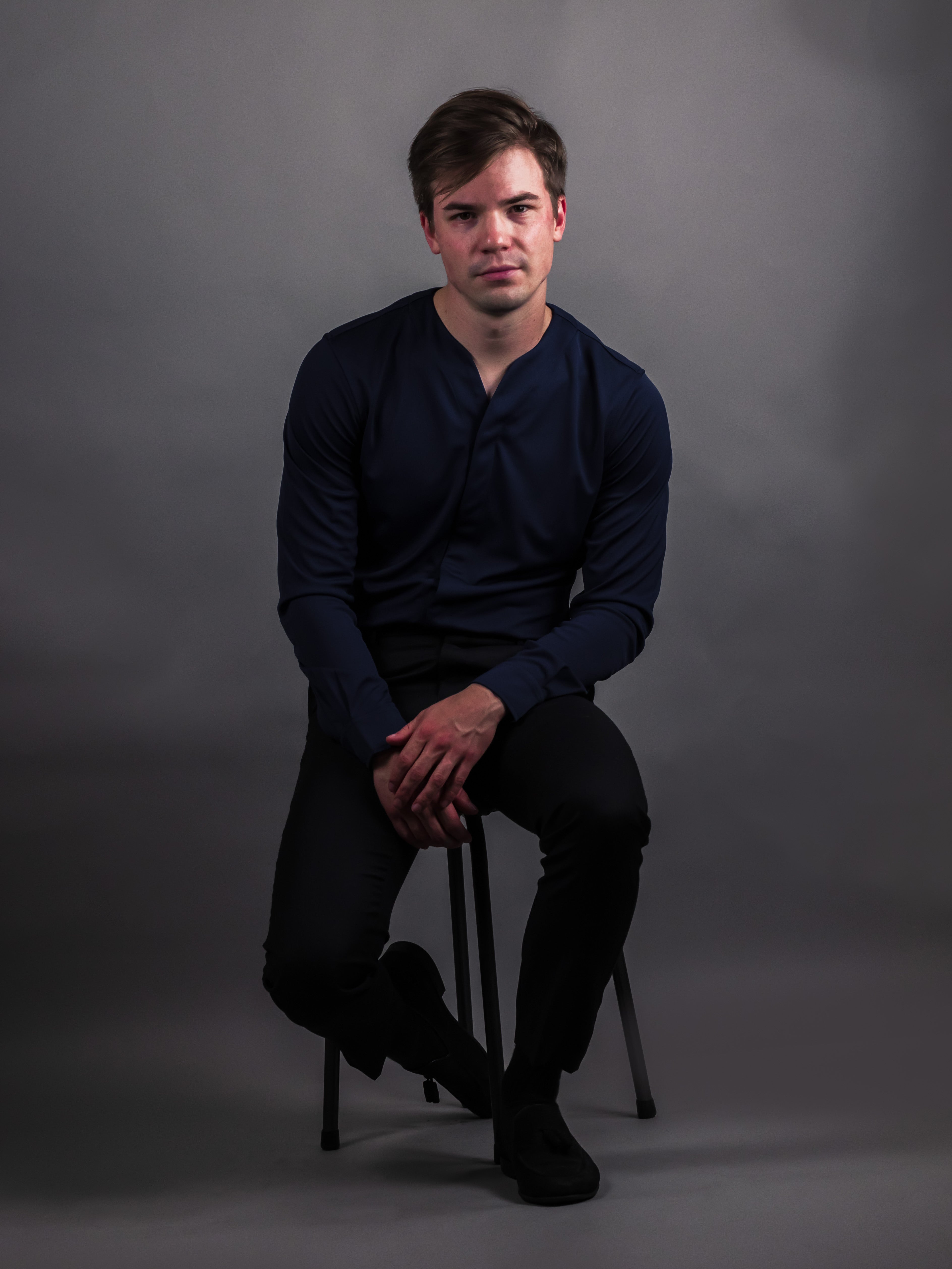 Model wearing a collarless dress shirt for men in navy blue