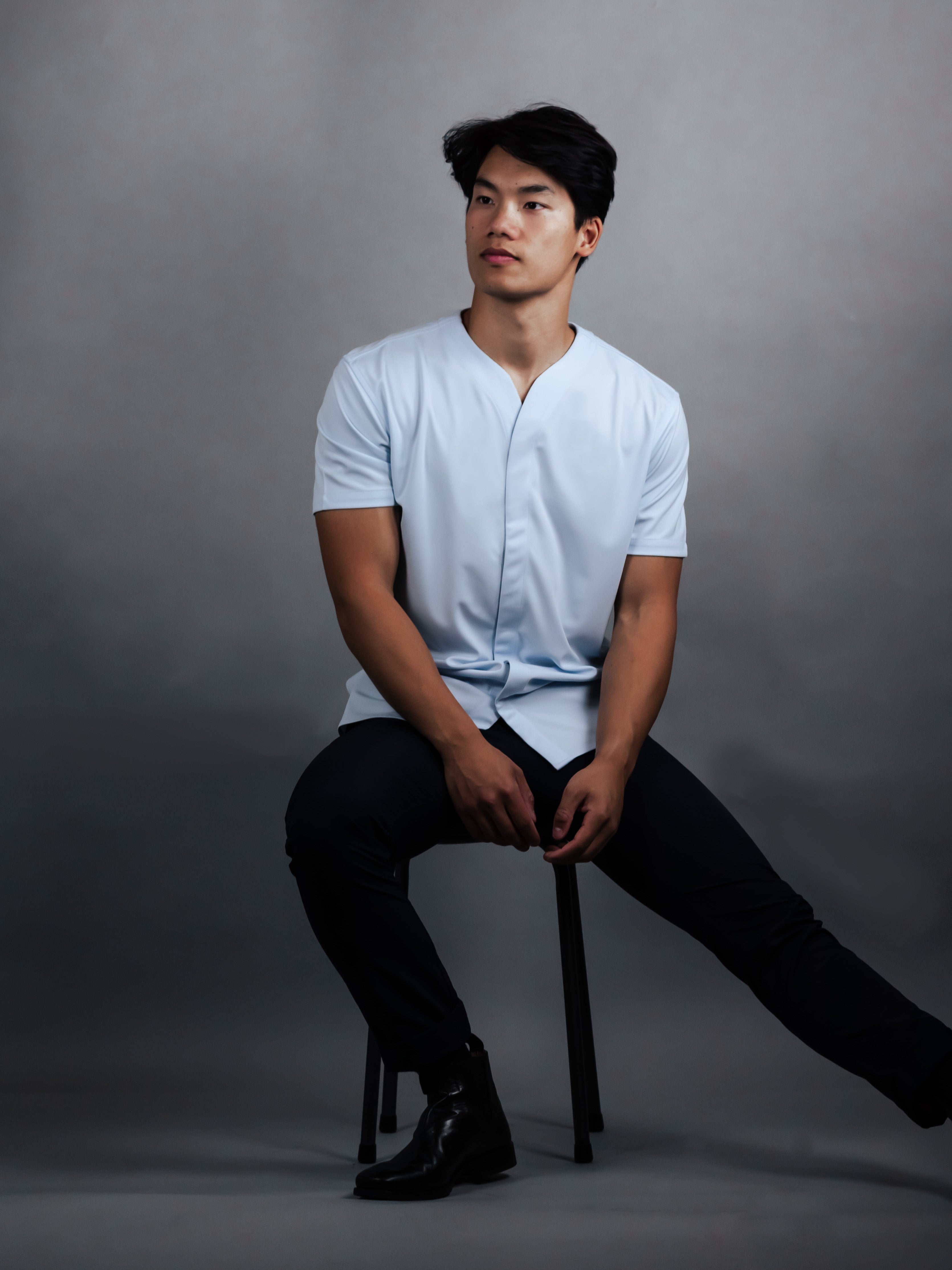 Man in chair wearing a slim fitted shirt made by cheegs