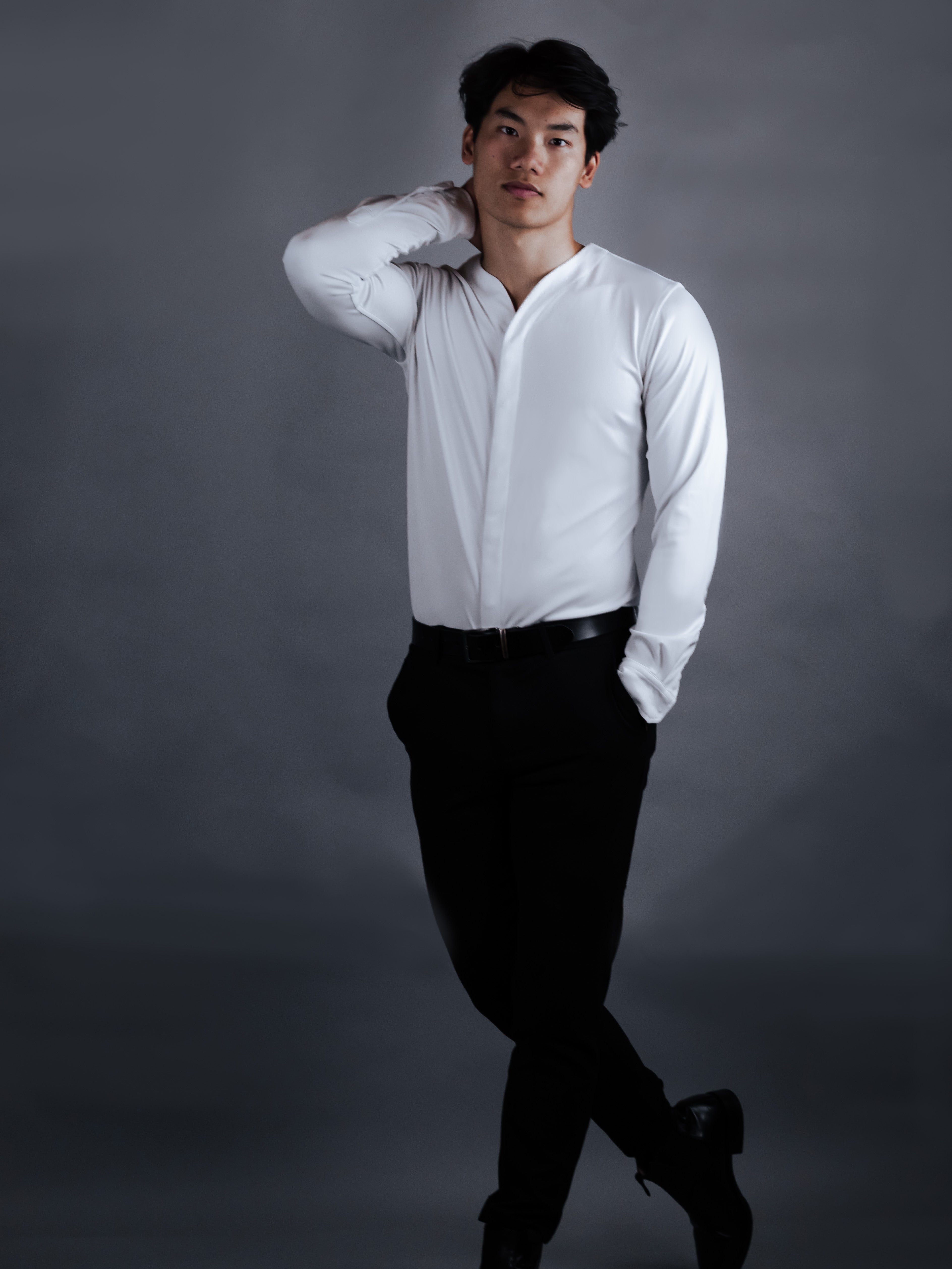 Model with a modern dress shirt on with dark pants
