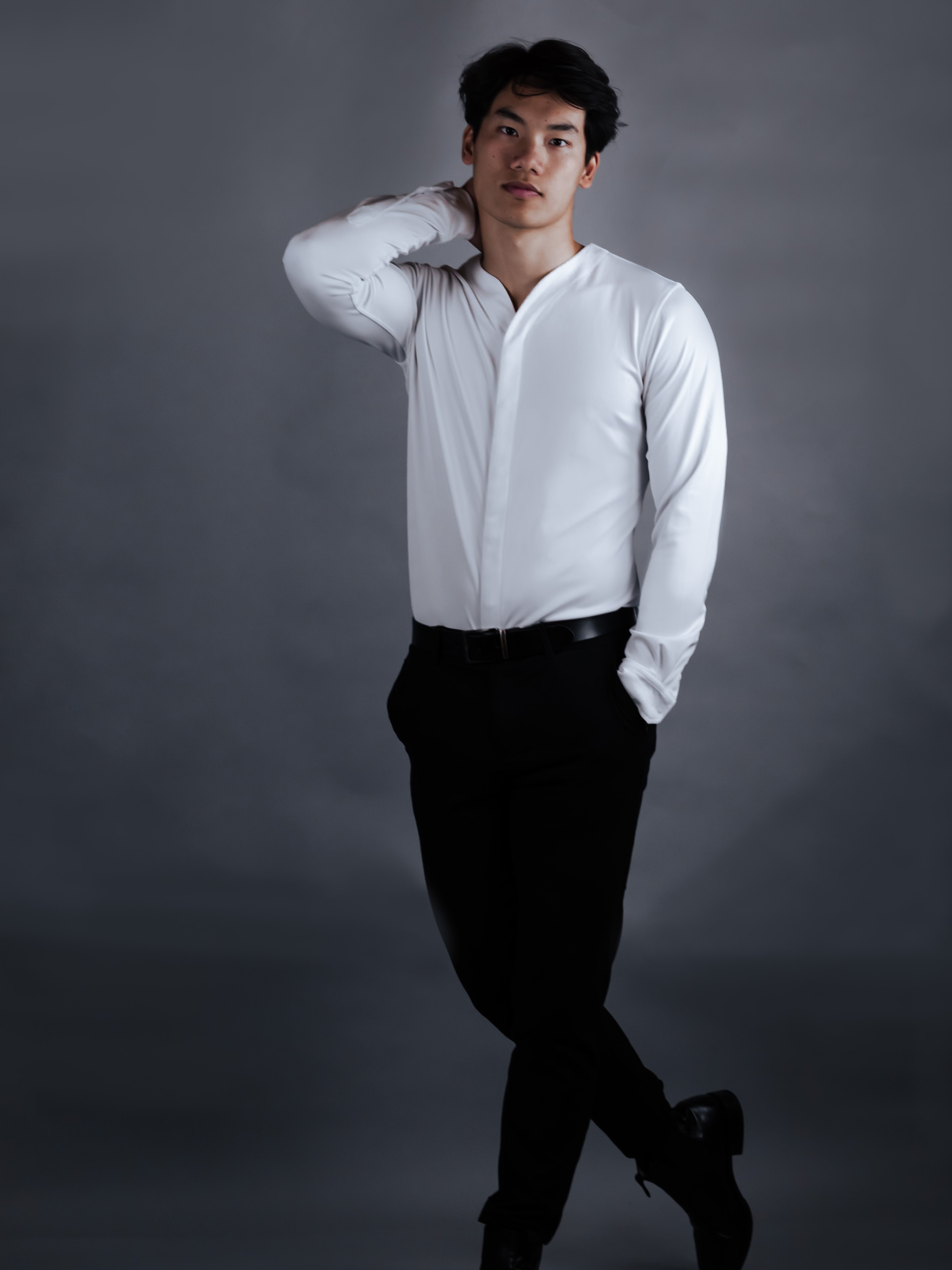 Model with a modern dress shirt on with dark pants