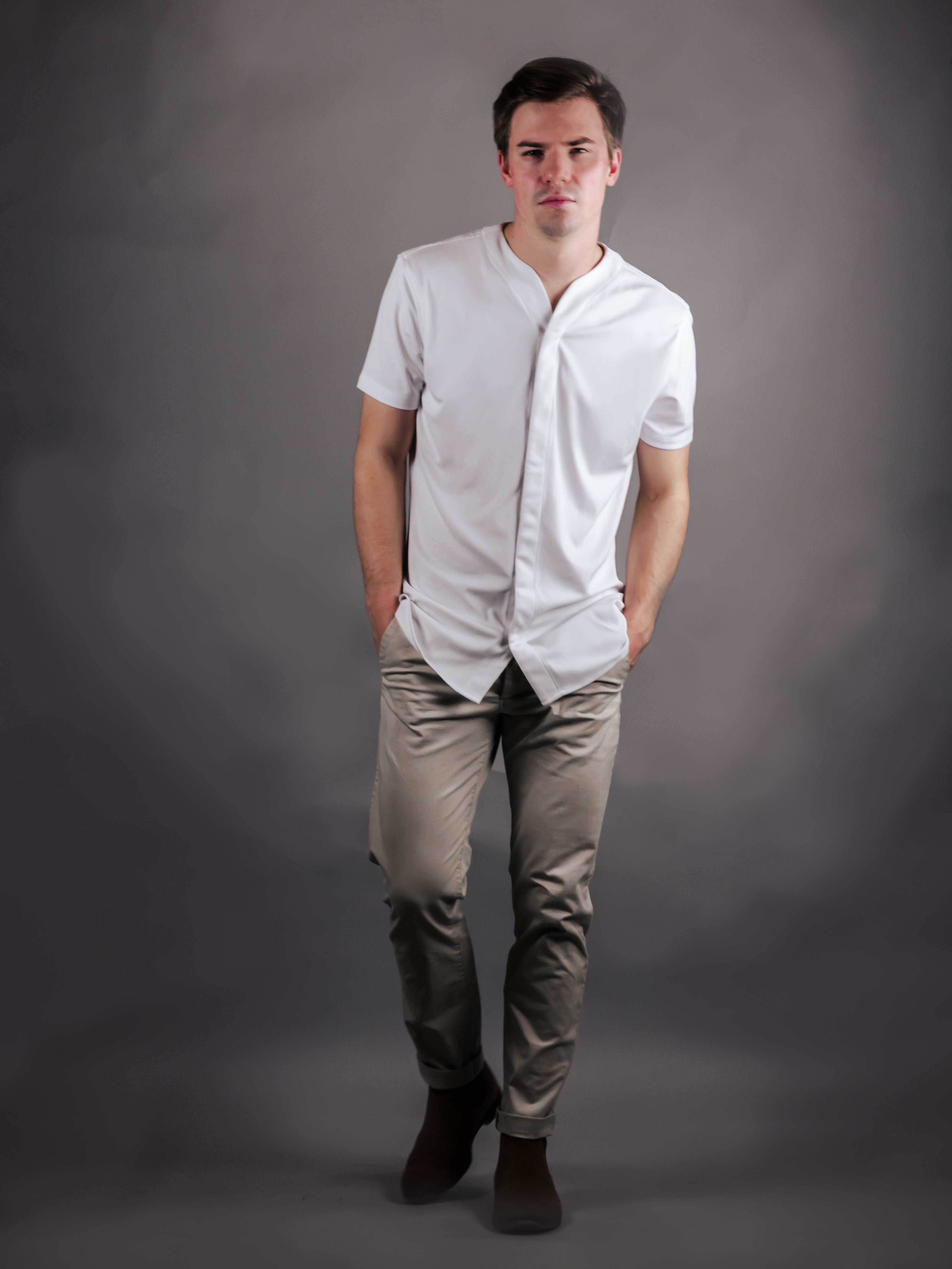 Man wearing tan pants with a white Cheegs shirt for a modern collarless look