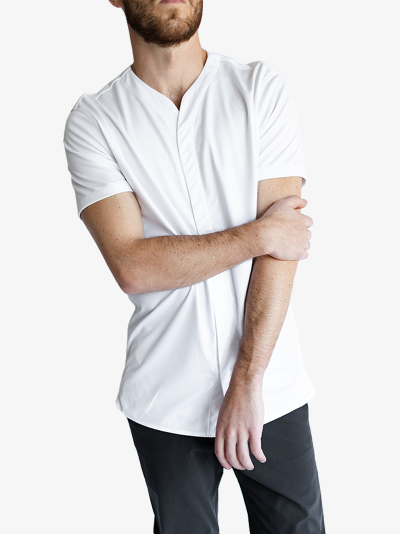 Man wearing white collarless short sleeve shirt with dark pants