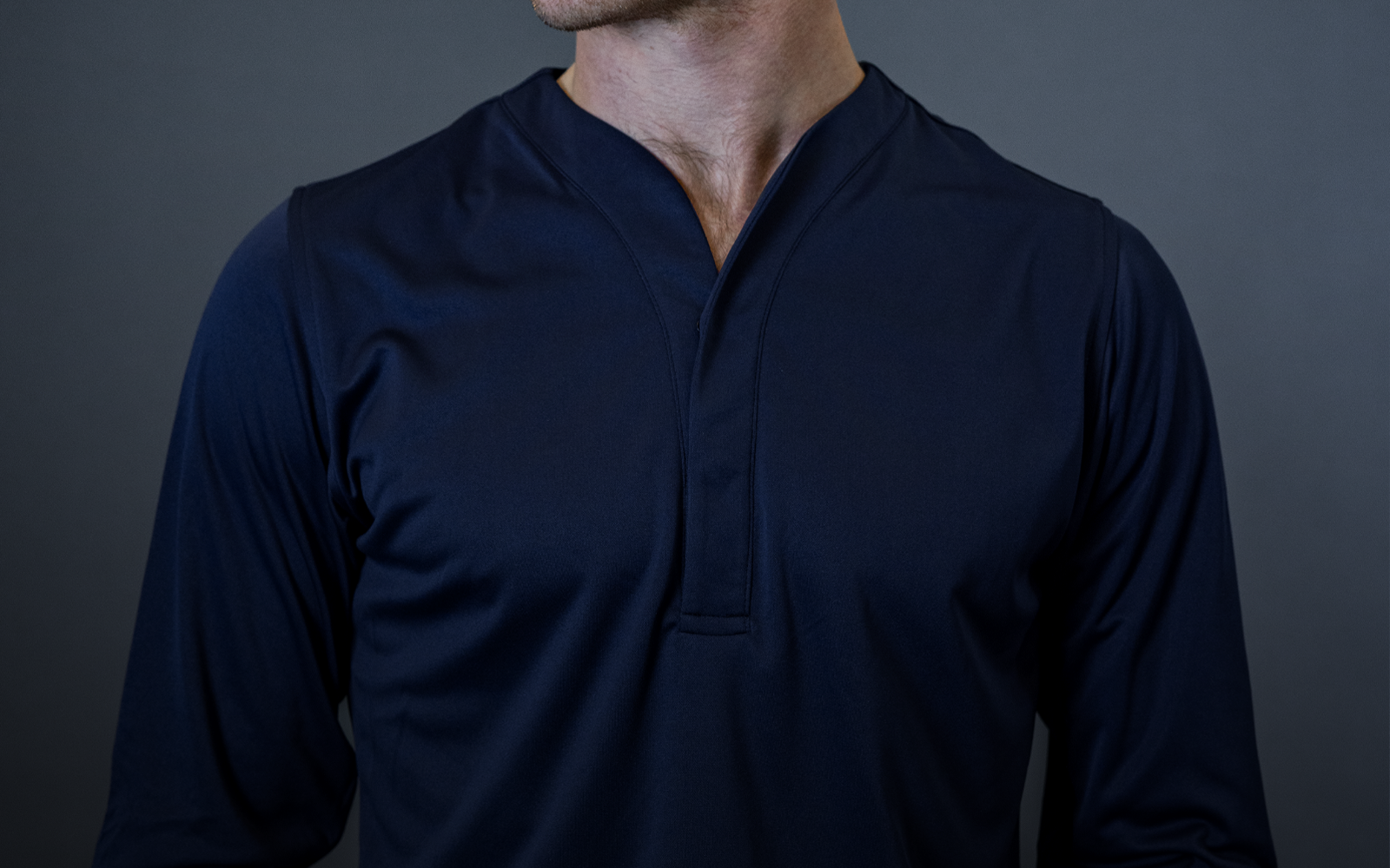 man wearing cheegs collarless dress shirt in dark blue. 