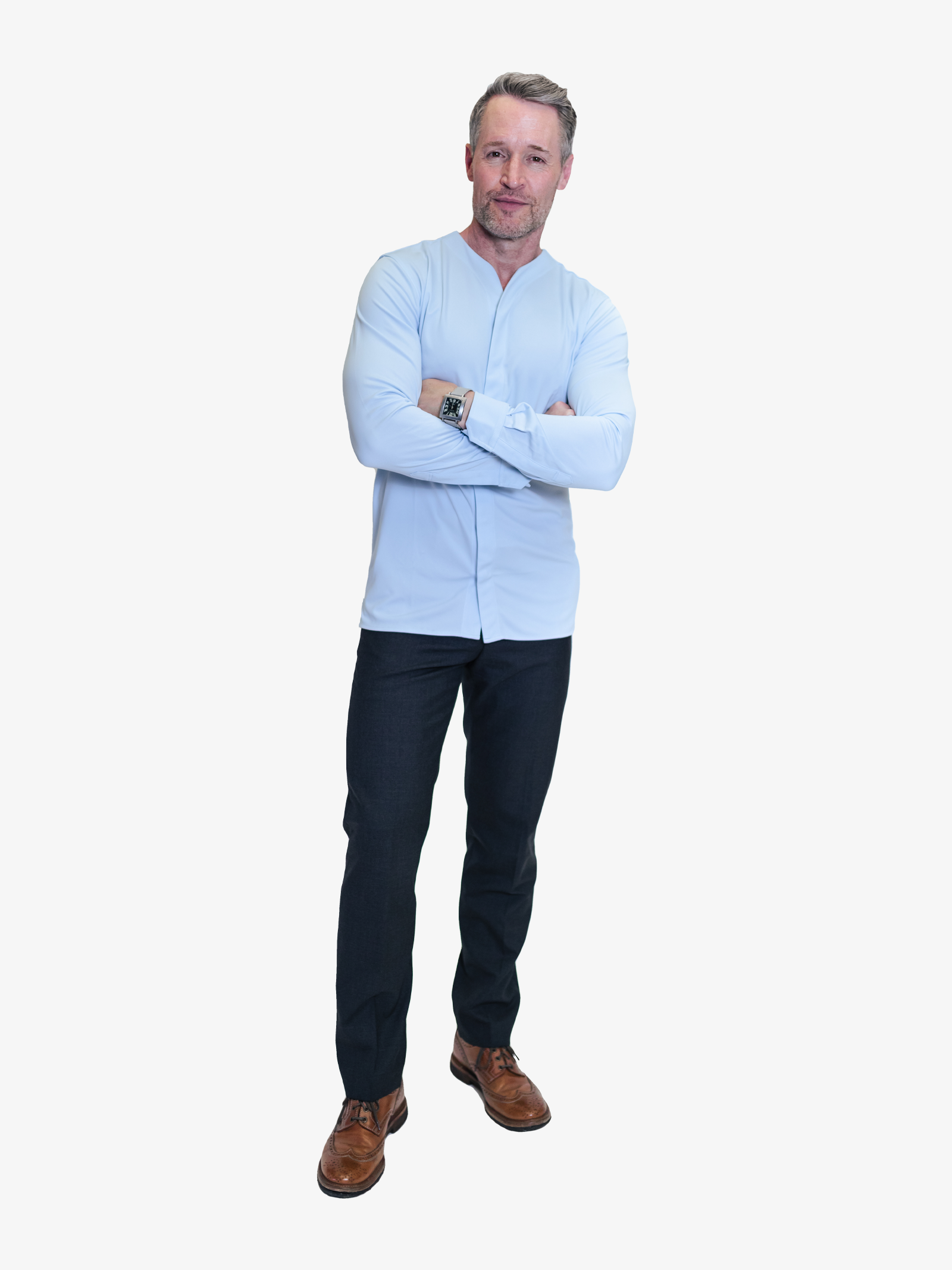 Man wearing a collarless button down in blue casually with a pair of dark slacks and brown shoes