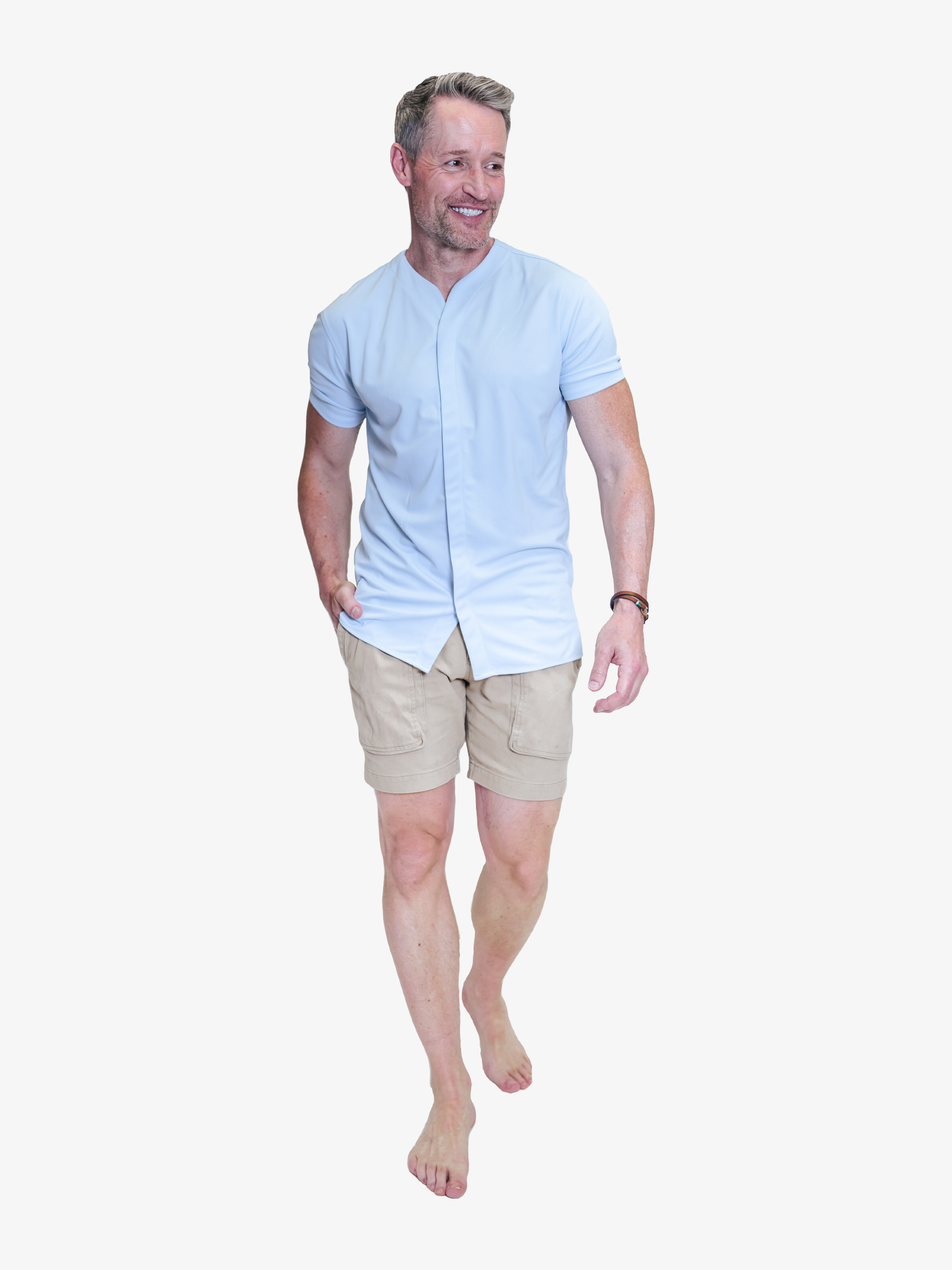 handsome model wearing a collarless short sleeve shirt in light blue styled with deep pocket khakis 