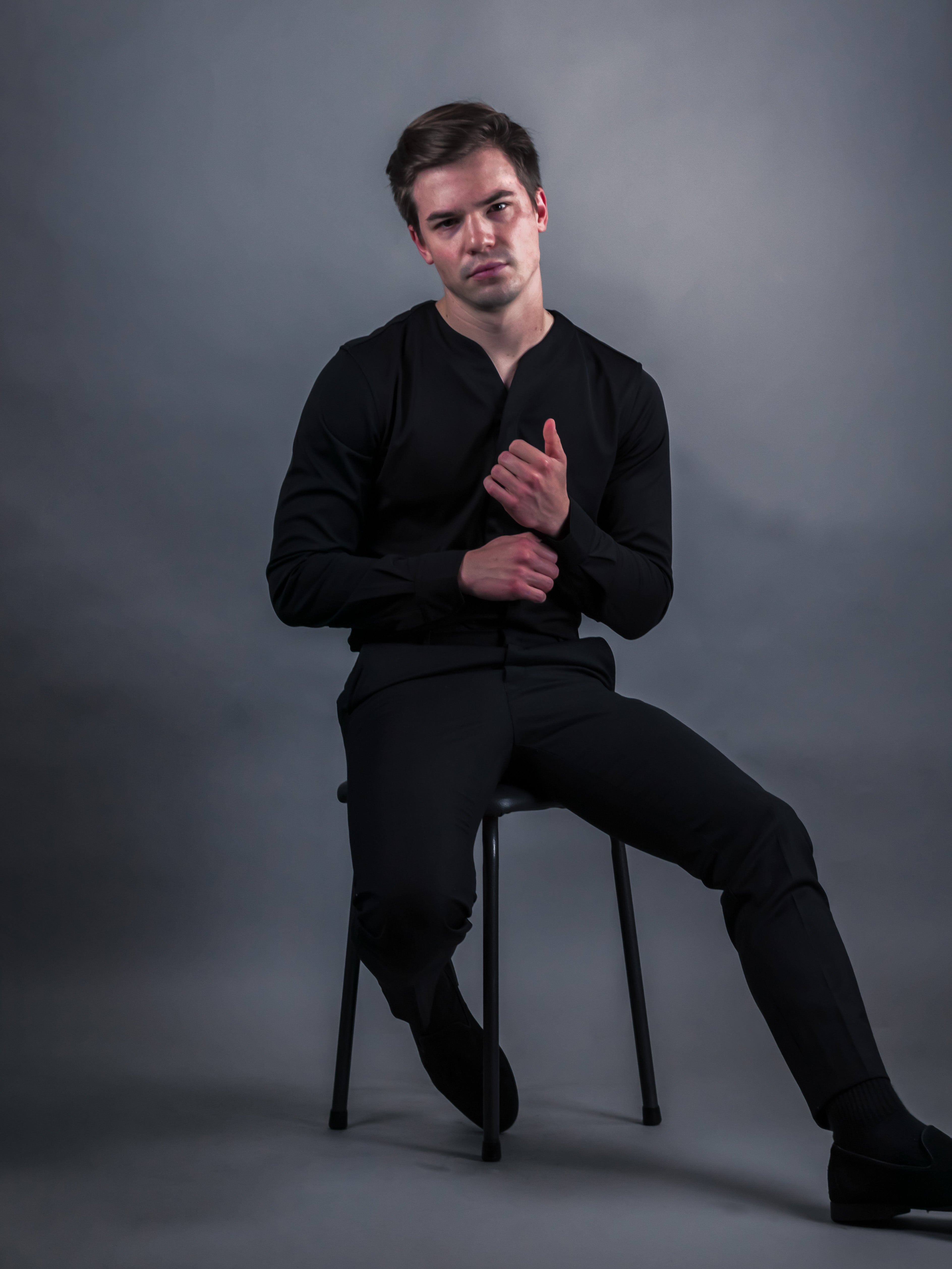 Young man wearing men's collarless shirt in black with a new style of shirting