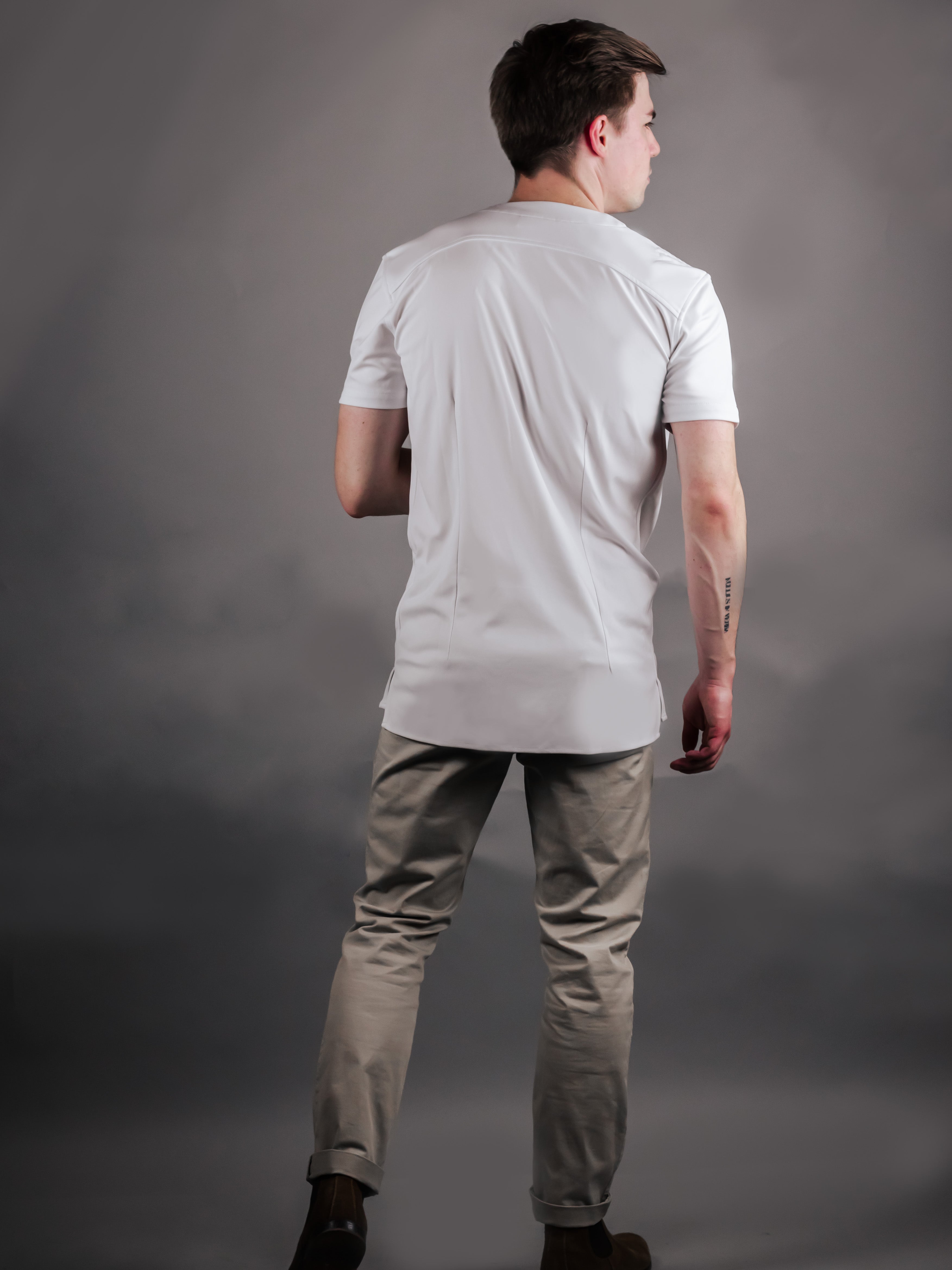 modern model wearing a collarless short sleeve dress shirt showing the back