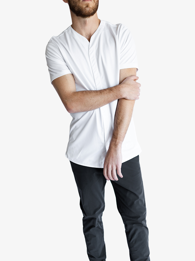 man wearing collarless short sleeve shirt in white with dark pants